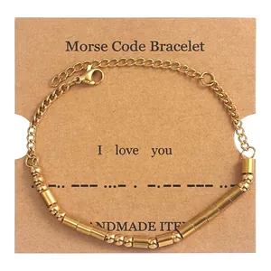 Detail of Morse code beaded bracelet on 'I love you' card featuring gold beads and tubes
