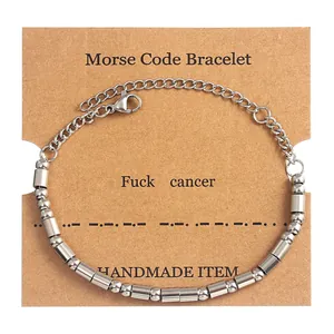 Silver Morse code bracelet with beads and tubes displayed on a brown kraft card
