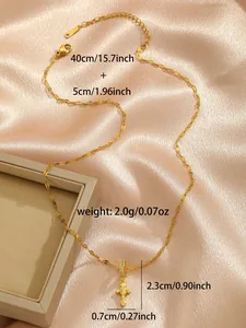 Macro shot of gold cross necklace with dimension labels 40cm length and 2.3cm pendant