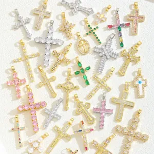 Various Zirconia Cross Pendants in Gold, Silver, and Rose Gold Finishes on White Surface
