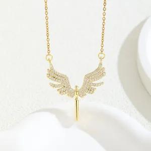 Golden angel wing pendant necklace with micro-paved zircons on a white display stand