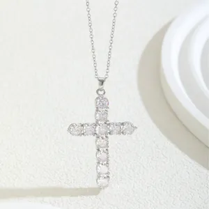 Classic silver cross necklace with pavé cubic zirconia on a minimalist textured backdrop