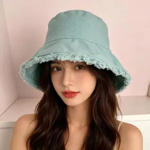 Light green bucket hat with frayed edges for women, trendy sun protection accessory