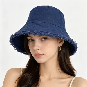 Deep blue washed cotton bucket hat with frayed edges shown on a fashion model