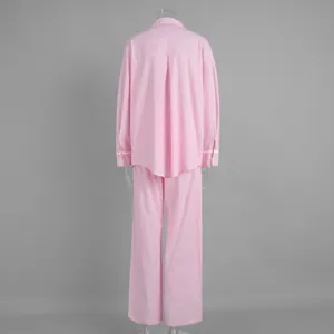 Rear view of pink striped lounge set featuring back pleat and delicate lace cuffs