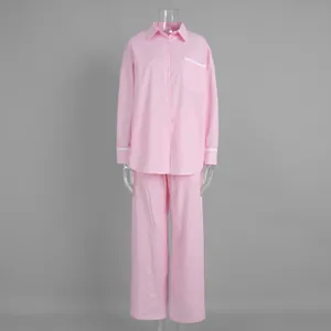Close-up of pink striped shirt sleeve with white lace trim and breathable cotton fabric