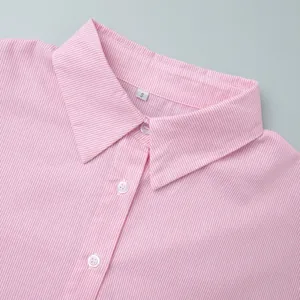 Close-up of classic lapel collar on pink striped shirt with white buttons and size S label