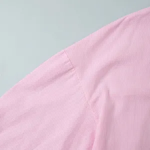 Detail of pink striped shirt sleeve seams showing precise stitching and smooth fabric