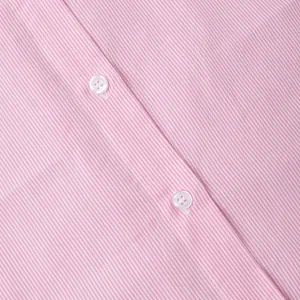 Detailed close-up of pink and white striped fabric with white button placket and stitching