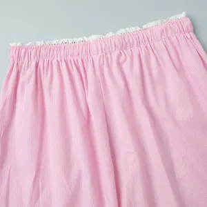 Detail of pink striped pants with elastic waist and delicate white lace trim