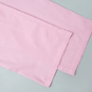 Detailed macro view of pink striped fabric texture and clean stitched hem of the trousers