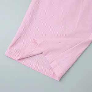 Detail shot of pink and white striped fabric hem with high-quality flat-stitched seams