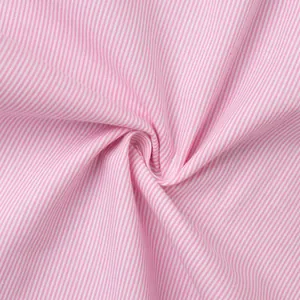 Close-up of pink and white striped fabric texture showing soft draping and fine weave