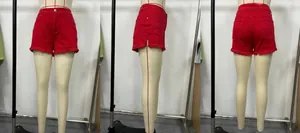 Three-way view of bright red denim shorts featuring frayed edges and distressed details