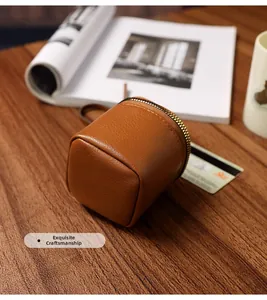 Close-up of vintage brown leather mini round coin purse with lychee texture and zipper