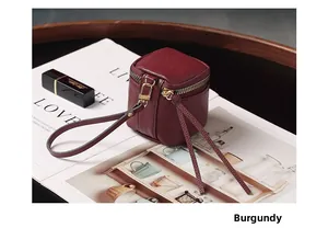 Close-up of wine red lychee pattern leather mini pouch with gold metal zipper detail