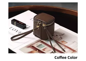 Close-up of coffee brown lychee grain leather mini bag with gold zipper detail