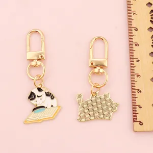 Cute cartoon cat reading book alloy keychain with gold-tone lobster clasp and ring