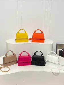 Mini solid color crossbody bags with knot handles in six vibrant assorted colors