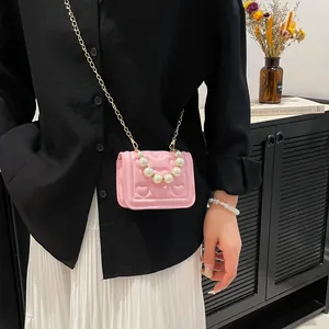 Pink heart quilted kids crossbody bag with large pearl handle and gold chain strap