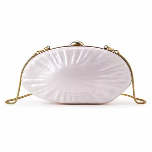 Iridescent white acrylic shell clutch bag with gold chain strap for wedding dinners