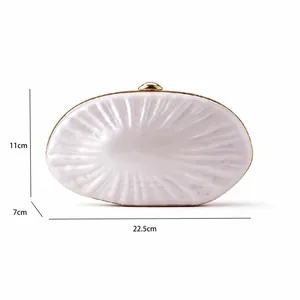 Detailed view of white pearl shell clutch bag showing dimensions 22.5cm by 11cm