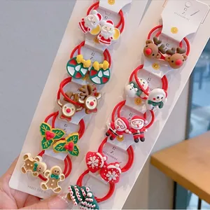 Christmas hair tie set featuring Santa, reindeer, and gingerbread men on a red display card