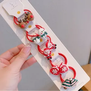 Christmas hair tie set featuring Santa, reindeer and snowman resin charms on red elastic bands