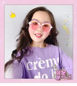 Toddler model wearing cute pink round sunglasses with rainbow and cloud frame decor