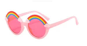 Detail of pink children's sunglasses with rainbow and cloud decorative elements