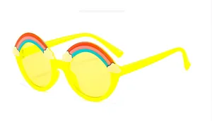 Detail of yellow round kids sunglasses with colorful rainbow and white cloud decor