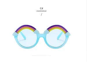 Detail of round light blue kids sunglasses with rainbow and white cloud decorations