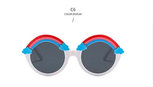 Close-up of white round kids sunglasses with a colorful rainbow and cloud design