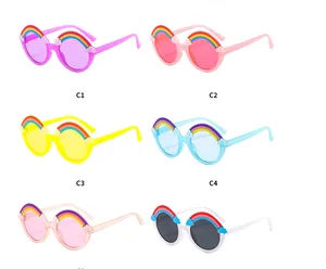 Flat lay of rainbow themed kids sunglasses in six pastel colors on white background