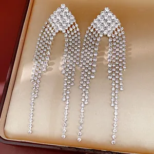 Close-up detail of elegant silver rhinestone tassel earrings in luxury jewelry box