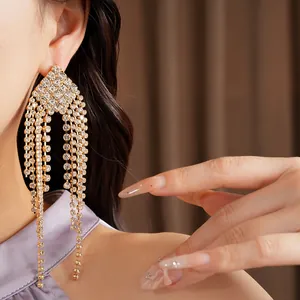 Detailed macro view of elegant silver needle earrings with long rhinestone tassels
