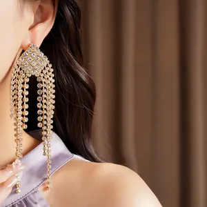 Detail shot of sparkling rhinestone rhombus tassel earrings shown on an Asian model
