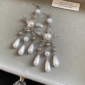 Elegant silver starfish earrings with white pearl tassels and teardrop drops