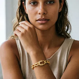 18K gold plated titanium steel bangle with a zircon-encrusted C buckle shown on wrist