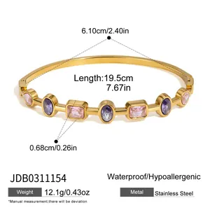 Detail view of gold-plated stainless steel bracelet featuring purple and pink crystal stones