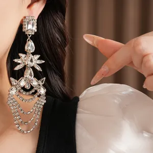 Dramatic silver drop earrings with crystal tassels and geometric rhinestone details