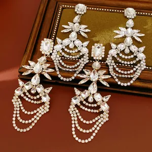 Close-up of sparkling rhinestone dangling earrings with multi-layer chain tassels