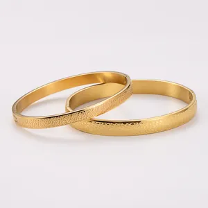 Detail view of luxury 18k gold plated stainless steel bangles with spotted texture