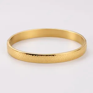 Close-up of a 18K gold plated stainless steel bangle with a unique spotted texture