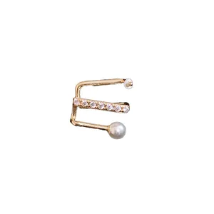 Minimalist gold-tone ear cuff with shimmering cubic zirconia and round white pearl