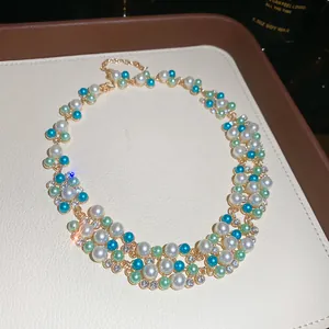 Close-up of elegant French retro pearl necklace with colorful beads and sparkling rhinestones