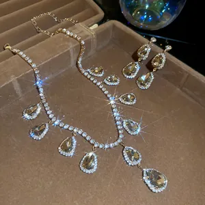 Close-up of luxury rhinestone teardrop pendant necklace and earrings set in a box