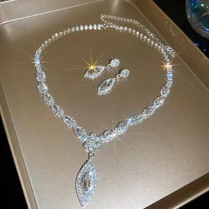 Close-up of sparkling rhinestone marquise pendant necklace and matching teardrop earrings.