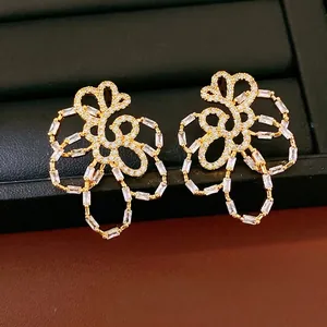 Elegant 18k gold plated hollow floral stud earrings featuring sparkling white zirconia