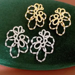 Intricate 18k gold plated hollow flower earrings with sparkling cubic zirconia stones